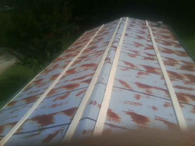 Rusted metal roof panels with new wood purlins before replacement — Storm Damage Roof Repair in Robersonville by Roofing Brothers